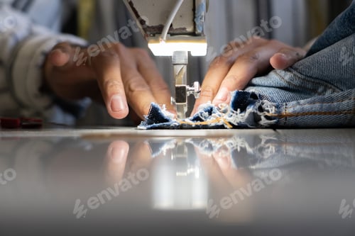 Preview: Man's hands sewing on a sewing machine