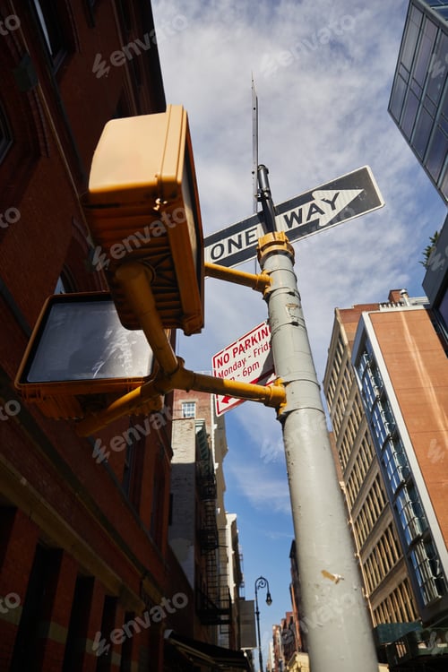 Preview: low angle view of street pole with road signs and traffic lights in new york city, urban signage