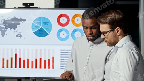 Preview: Business people at a meeting after a presentation on the background of statistics in the office