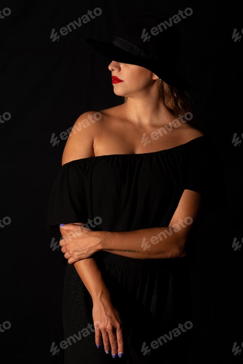 Preview: Portrait of a young caucasian woman wearing black hat holding hands