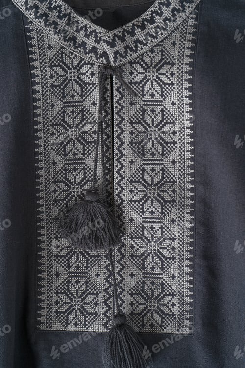 Preview: Ukrainian clothes embroidered man shirt. Blue gray and black threads background. Vyshyvanka is a