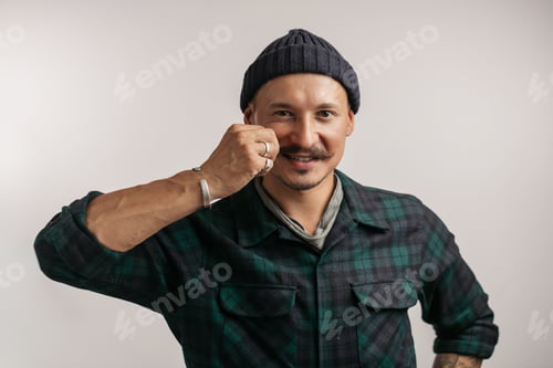Preview: smart professional expert handyman wearing knitted hat isolated in studio