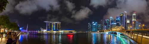 Preview: Panoramic night view of a vibrant cityscape by the waterfront