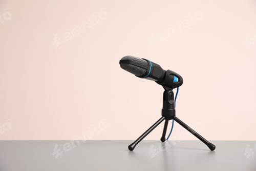 Preview: Microphone on light grey table, space for text. Journalist's work