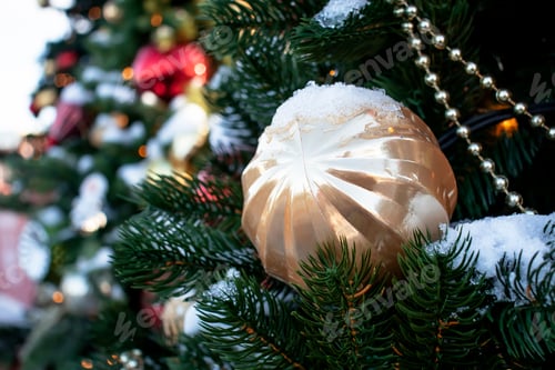 Preview: Christmas tree decorated with colorful balls and toys in the snow