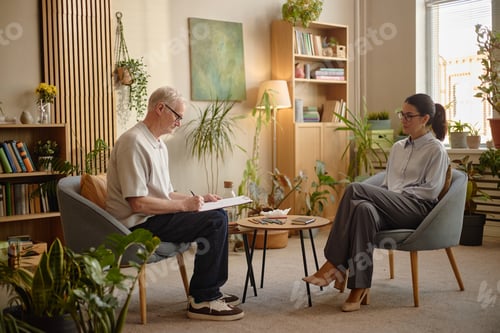 Preview: Senior Caucasian Man Discussing Mental Health with Young Adult Woman Therapist