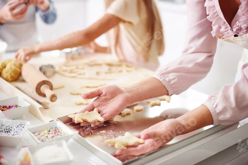 Preview: Cropped shot of girl and mother easter baking at kitchen counter