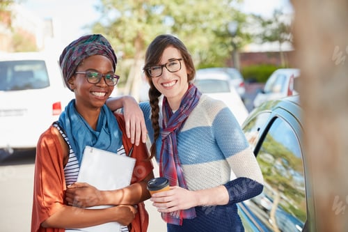 Preview: College life has been great. Portrait of two university students hanging out between class.