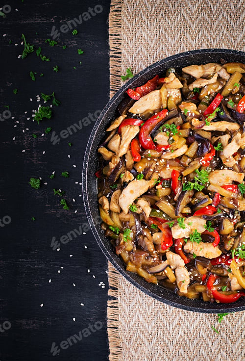 Preview: Stir fry with chicken, eggplant, zucchini and sweet peppers - Chinese food. Top view, above