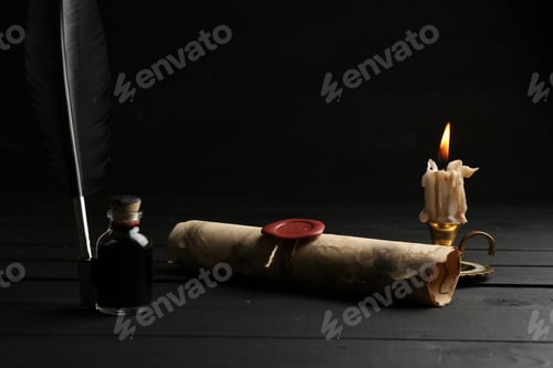 Preview: Old rolled scroll, feather, inkwell and burning candle on black wooden table, closeup