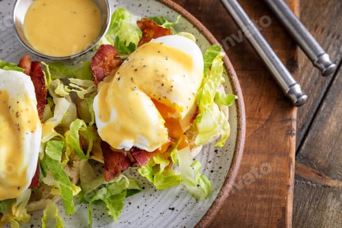 Preview: Eggs Benedict with bacon and lettuce on english muffins