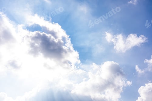 Preview: Beautiful cumulus clouds with sunlight. The direct rays of the sun shine through the clouds.