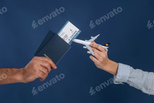 Vista previa: Ticket and toy plane. Close up view of woman's and man's hands that are ready for vacation