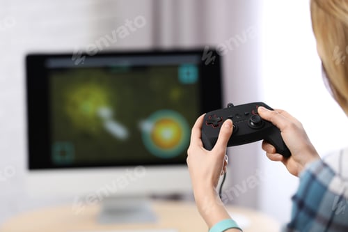 Preview: Young woman playing video game at home, closeup