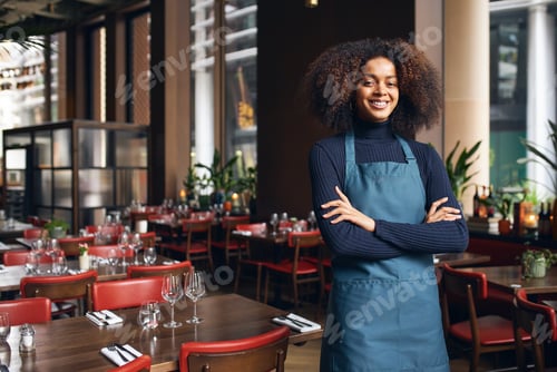 Preview: Cheerful small business owner in restaurant