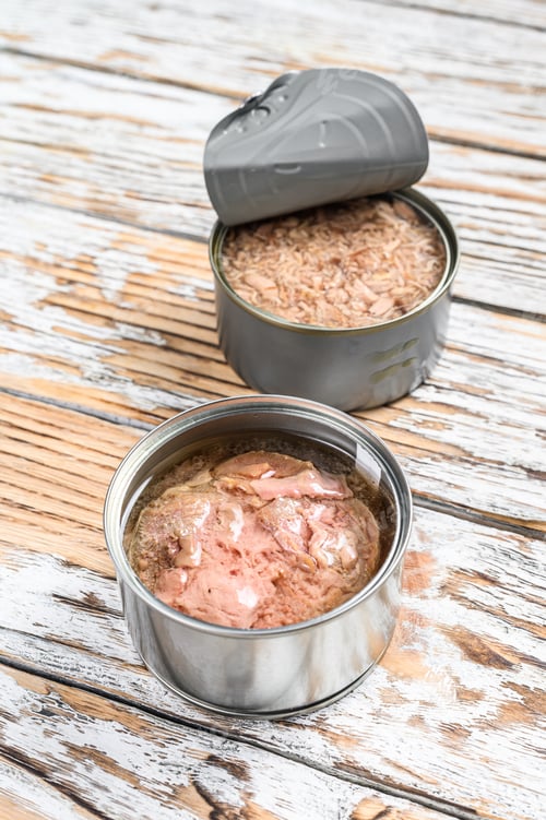 Preview: Canned tuna in a jar. Grey wooden background. Top view. Copy space