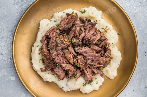 Preview: Homemade French Beef Bourguignon Stew on a plate with mashed potatoes. grey background. top view