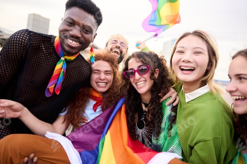 Preview: Happy group posing with rainbow flag for a fun event