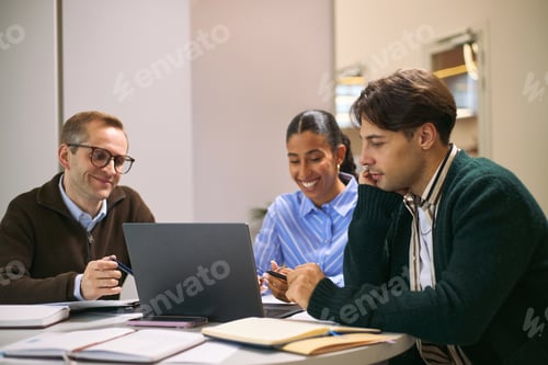 Preview: Multiethnic Young Adults Brainstorming Business Solutions Around Laptop Together
