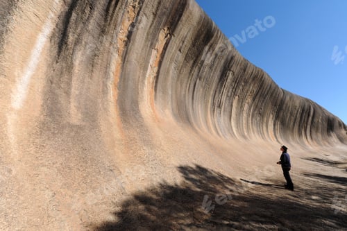 Preview: Person at the popular tourist attraction of Wave Rock