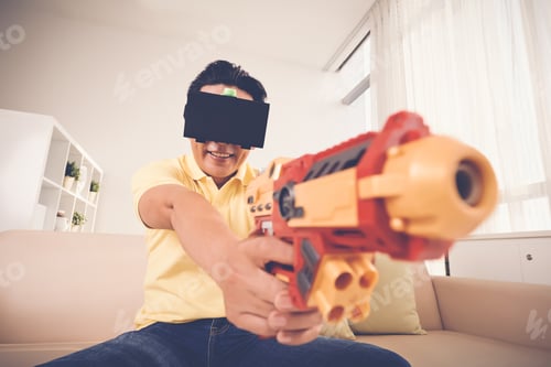 Man with toy gun and VR headset at home
