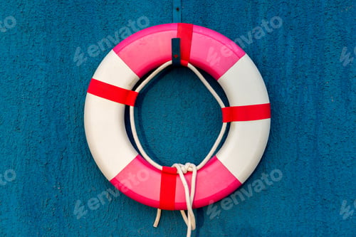 Preview: red and white life belt hanging on blue wall