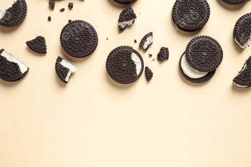 Preview: Tasty chocolate cookies with cream on color background, flat lay. Space for text
