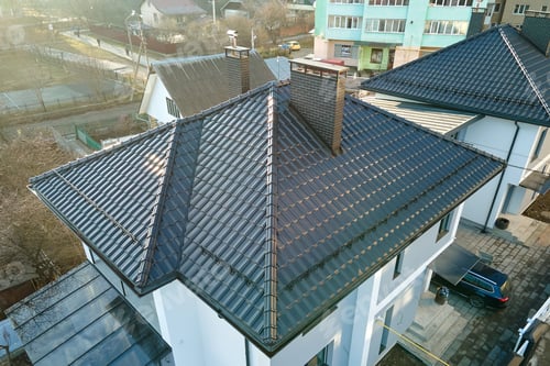 Preview: Aerial view of private house with ceramic shingles covered roof top. Investment in real estate