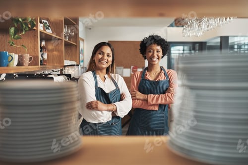 Preview: Cropped shot of two young women working in a cafe