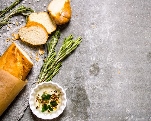 Preview: Ciabatta wrapped in paper with rosemary and oil.