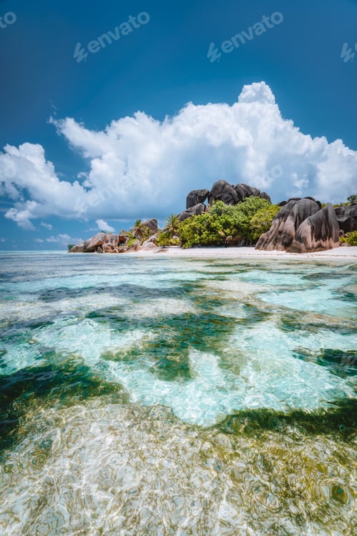 Preview: La Digue island, Seychelles. Famous paradise beach Anse Source d'Argent with shallow blue lagoon