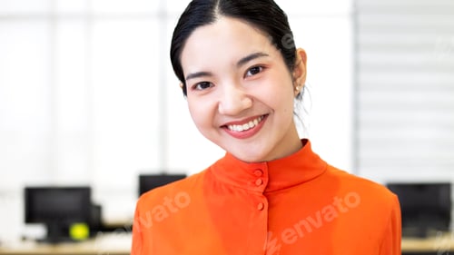 Preview: Smiling Young Woman Poses in an Office Setting