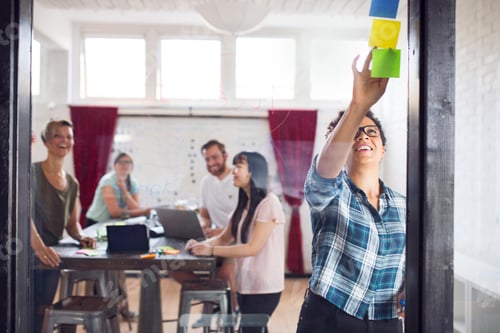 Preview: Group of coworkers brainstorming in office