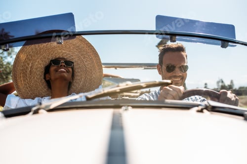 Preview: Multiracial couple in a convertible vintage car