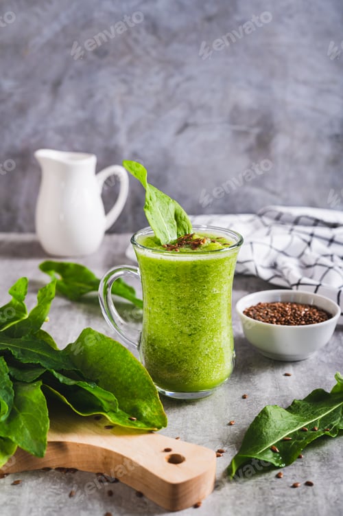 Preview: Refreshing smoothie made from sorrel leaves and flax seeds in a glass on the table vertical view