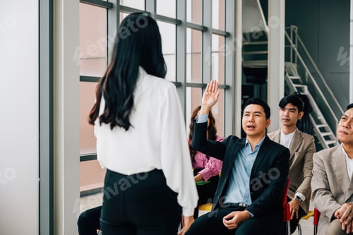 Preview: In the midst of a conference, a young man eagerly raises his hand to pose a question. The group