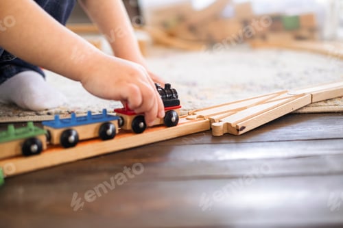 Preview: Close-up of children's hands playing with trains. The kid spends time playing.