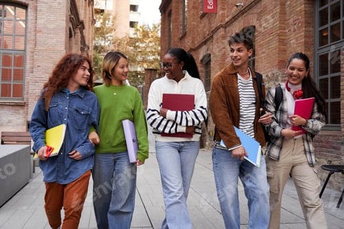 Preview: Internacional group of university students walking and talking at school campus going to class.