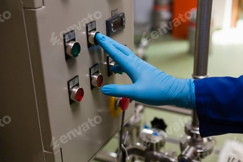 Preview: Cropped hand of worker pressing button of machinery