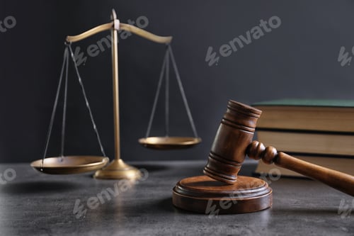 Preview: Judge's gavel and blurred scales on background. Law concept