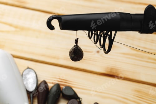 Preview: Spinning for fishing on wooden background close up