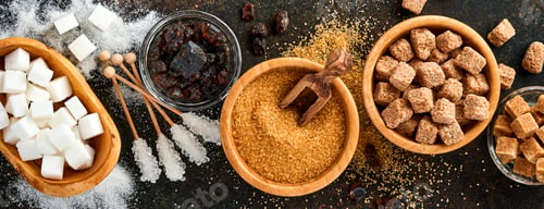 Preview: White sugar, cane sugar cubes, caramel in bamboo bowl on dark brown table concrete background. Assor