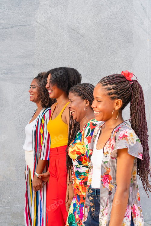 Preview: Group of friends laughing while walking together in the city street.