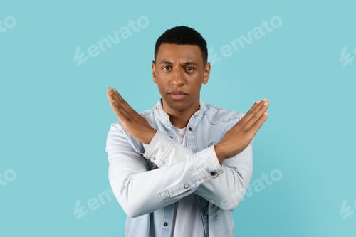Preview: Sad serious handsome young african american man in casual crossed arms doing stop sign