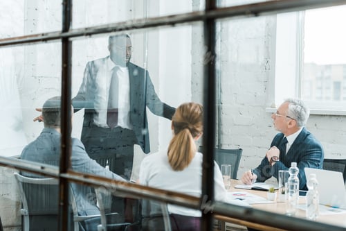 Preview: selective focus of african american business coach talking and gesturing near coworkers