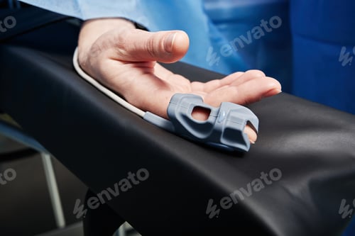 Preview: Pulse oximeter on patient's finger for detection of oxygen saturation during operation in hospital.