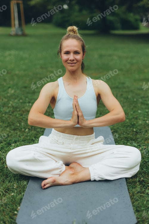 Preview: young woman athlete in sportswear practices yoga, enjoys training