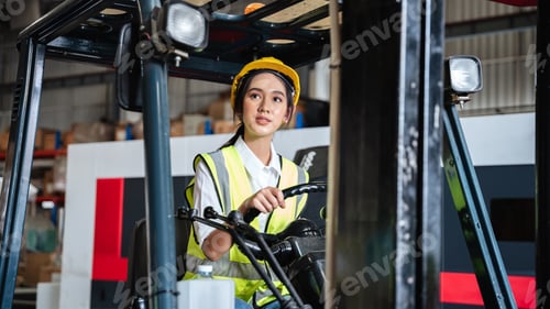 Preview: Warehouse worker working with a forklift in a warehouse or storehouse.