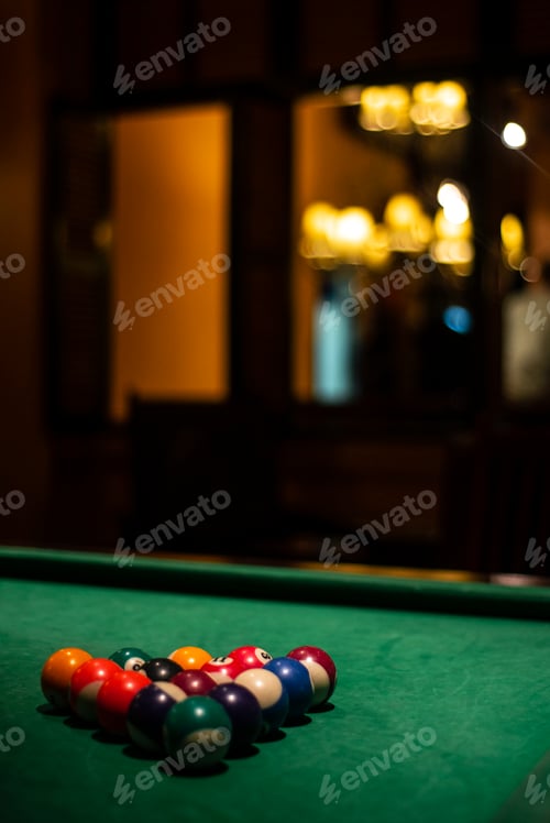 Preview: billiards balls on pool table in cozy dark bar interior