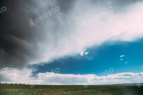 Preview: Countryside Rural Field Spring Meadow During Rain. Rain Clouds On Horizon. Agricultural And Weather